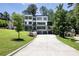 A modern home with a long driveway leading up to the two car garage and manicured lawn at 2110 Fairway Ne Cir, Brookhaven, GA 30319