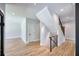 Open hallway features light gray walls, light wood floors, and a modern staircase with a black metal railing at 2110 Fairway Ne Cir, Brookhaven, GA 30319