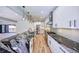 Modern kitchen features sleek white cabinetry, stainless steel appliances, and a large island with black marble at 2110 Fairway Ne Cir, Brookhaven, GA 30319