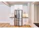 Close-up of a modern kitchen with white cabinets, stainless steel fridge, and marble countertops at 2110 Fairway Ne Cir, Brookhaven, GA 30319