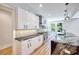 Stylish kitchen featuring white cabinets, stainless steel appliances, and a striking marble countertop island at 2110 Fairway Ne Cir, Brookhaven, GA 30319