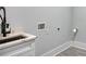 Laundry room featuring a modern sink with a white countertop, gray cabinets and gray flooring at 2110 Fairway Ne Cir, Brookhaven, GA 30319