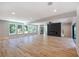 Spacious living room with hardwood floors, a dark fireplace, and ample natural light from large windows at 2110 Fairway Ne Cir, Brookhaven, GA 30319