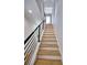 Bright staircase with light wood treads, white risers, and a sleek black metal railing leads to the next level at 2110 Fairway Ne Cir, Brookhaven, GA 30319