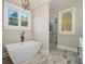 Spa-like bathroom featuring a freestanding tub and a separate glass-enclosed shower with stylish fixtures at 2226 Upper Burris Rd, Canton, GA 30114