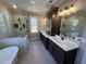 Elegant bathroom featuring double vanity, frameless glass shower with tile surround, and soaking tub at 2226 Upper Burris Rd, Canton, GA 30114