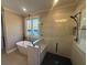 This bathroom features a walk-in shower with a built-in bench seat and black accents at 2226 Upper Burris Rd, Canton, GA 30114