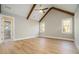 Bright, airy bedroom with vaulted ceilings, exposed wooden beams, and hardwood flooring throughout at 2226 Upper Burris Rd, Canton, GA 30114