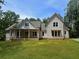 Charming two-story home with vertical siding, dormer windows, covered front porch, and a spacious front lawn at 2226 Upper Burris Rd, Canton, GA 30114
