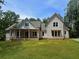 Charming two-story home with vertical siding, dormer windows, covered front porch, and a spacious front lawn at 2226 Upper Burris Rd, Canton, GA 30114