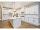 Bright kitchen with white cabinetry, stainless steel appliances, a central island, and hardwood floors at 2226 Upper Burris Rd, Canton, GA 30114