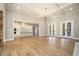 Bright open-concept living area with hardwood floors, coffered ceilings, and open to the kitchen with island at 2226 Upper Burris Rd, Canton, GA 30114