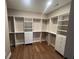 Custom walk-in closet with built-in shelves, drawers, and hanging rods to maximize storage space at 2226 Upper Burris Rd, Canton, GA 30114
