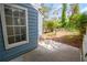 The backyard features a patio and a small grassy area surrounded by greenery at 3263 Long Iron Pl, Lawrenceville, GA 30044