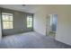Bedroom featuring neutral carpet, a plank accent wall, and an en-suite bathroom at 3263 Long Iron Pl, Lawrenceville, GA 30044