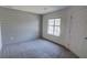 Bedroom featuring carpet, a window for natural light, and a painted plank accent wall at 3263 Long Iron Pl, Lawrenceville, GA 30044