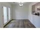 Dining room boasting wood floors, modern lighting, and a door to the exterior and open to the kitchen at 3263 Long Iron Pl, Lawrenceville, GA 30044