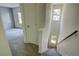 Hallway with carpeted stairs and a view of the living space with plank accent wall at 3263 Long Iron Pl, Lawrenceville, GA 30044