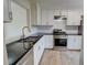 Updated kitchen featuring granite countertops, stainless steel appliances, and sleek white cabinetry at 3263 Long Iron Pl, Lawrenceville, GA 30044