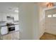 A bright galley kitchen featuring stainless appliances, stylish white cabinetry, and modern flooring at 3263 Long Iron Pl, Lawrenceville, GA 30044