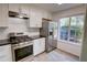Kitchen with stainless steel refrigerator and range, white subway tile backsplash, and granite countertops at 3263 Long Iron Pl, Lawrenceville, GA 30044