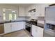 Bright renovated kitchen featuring stainless steel appliances and granite countertops with white cabinetry at 3263 Long Iron Pl, Lawrenceville, GA 30044