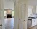 Open layout featuring white kitchen cabinets and view into the living room with fireplace at 3263 Long Iron Pl, Lawrenceville, GA 30044