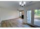 Bright living room featuring wood floors, a ceiling fan, fireplace, and glass doors to the exterior at 3263 Long Iron Pl, Lawrenceville, GA 30044