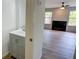 A powder room sink and cabinet are situated just off the living room with hardwood style floors at 3263 Long Iron Pl, Lawrenceville, GA 30044