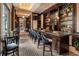 Stylish bar area with a long countertop, comfortable seating, and extensive shelving for displaying beverages and glassware at 3376 Peachtree Ne Rd # 35A, Atlanta, GA 30326