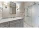 Elegant bathroom featuring a marble countertop vanity and a glass-enclosed shower with subway tile and modern fixtures at 3376 Peachtree Ne Rd # 35A, Atlanta, GA 30326