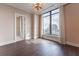 This bedroom boasts hardwood floors, a large window with city views, an ornate ceiling fan and a sliding door to the bath at 3376 Peachtree Ne Rd # 35A, Atlanta, GA 30326