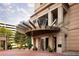 Elegant building entrance with a unique awning and landscaped surroundings offers a grand arrival experience at 3376 Peachtree Ne Rd # 35A, Atlanta, GA 30326
