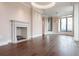 Bright living room featuring a cozy fireplace, hardwood floors, and large windows with city views at 3376 Peachtree Ne Rd # 35A, Atlanta, GA 30326