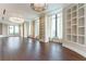 Expansive living room with hardwood floors, built-in shelving, and elegant chandelier lighting at 3376 Peachtree Ne Rd # 35A, Atlanta, GA 30326