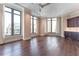 Bright living room with dark hardwood floors, neutral walls, and wet bar in background at 3376 Peachtree Ne Rd # 35A, Atlanta, GA 30326