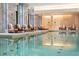 Relaxing indoor pool area featuring lounge chairs, columns, and serene lighting at 3376 Peachtree Ne Rd # 35A, Atlanta, GA 30326