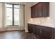 Wet bar area complete with dark wood cabinetry, granite countertop, and large window at 3376 Peachtree Ne Rd # 35A, Atlanta, GA 30326
