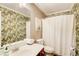 Stylish bathroom with a palm leaf patterned wallpaper at 5220 Wild Cedar Dr, Buford, GA 30518
