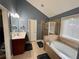 Bathroom featuring a walk-in shower, a separate soaking tub, and a single vanity at 5220 Wild Cedar Dr, Buford, GA 30518