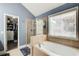 The main bathroom features a soaking tub, glass shower, and walk-in closet at 5220 Wild Cedar Dr, Buford, GA 30518
