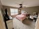 Bright bedroom with ceiling fan and large window at 5220 Wild Cedar Dr, Buford, GA 30518