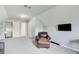 Spacious bonus room with seating, entertainment area, and bright natural light at 5220 Wild Cedar Dr, Buford, GA 30518