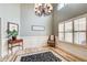 Formal dining room with wainscoting, chandelier, and bright windows at 5220 Wild Cedar Dr, Buford, GA 30518