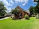 Exterior view of brick house, with a green lawn and well maintained landscaping at 5220 Wild Cedar Dr, Buford, GA 30518