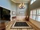Elegant foyer with chandelier, wood floors, and large windows with natural light at 5220 Wild Cedar Dr, Buford, GA 30518