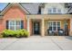 Inviting front entrance with stone pillars and charming decor at 5220 Wild Cedar Dr, Buford, GA 30518