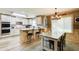 Well-lit eat-in kitchen features a center island, modern appliances, and beautiful countertops at 5220 Wild Cedar Dr, Buford, GA 30518