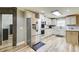 A bright kitchen is complete with stainless steel appliances, tile backsplash, and wood flooring at 5220 Wild Cedar Dr, Buford, GA 30518