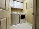 The laundry room has modern washer and dryer units and built-in cabinets for storage at 5220 Wild Cedar Dr, Buford, GA 30518